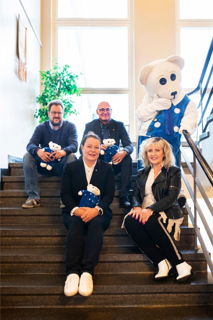 Kuvassa on Ti-Ti Nallen lisäksi Riitta Korpela, Hämeenkyrön yrityspalveluiden Markus Pikka, kunnanjohtaja Antero Alenius ja elinympäristöjohtaja Ritva Asula-Myllynen istumassa portaissa.